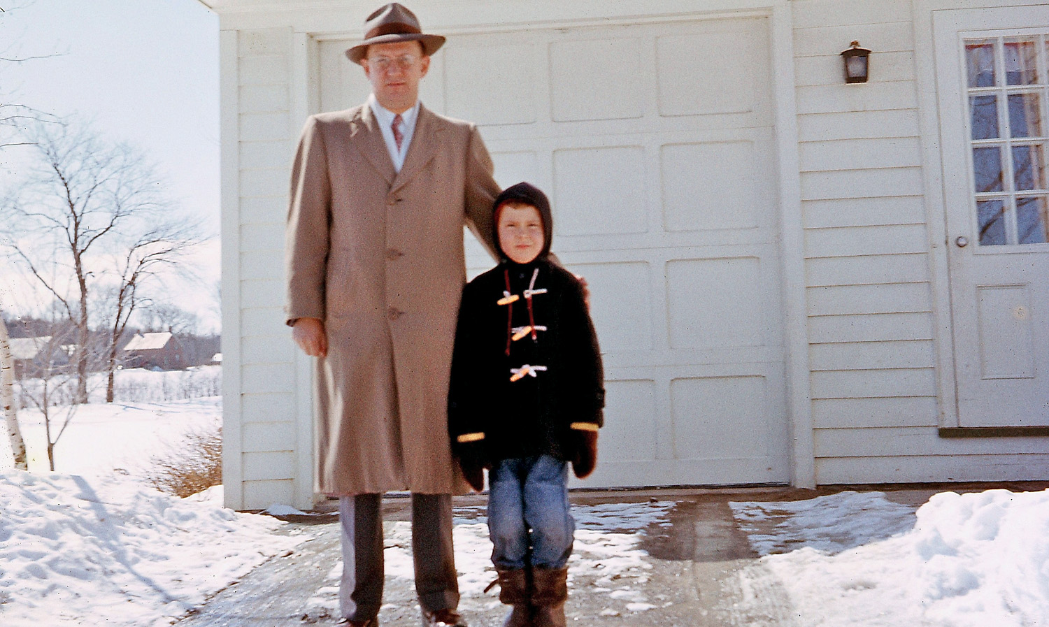 Same location as the Hula Hoop photo - our driveway - with Dad and me in winter 1958. We lived literally on the edge of town, as seen by the background countryside and woods. That was our playground, summer and winter, for my friends and me, the best childhood anyone could ask for. No helicopter parenting, no electronic distractions. We never felt we were missing something. A Google Earth view shows that countryside is now subdivision. View full size.