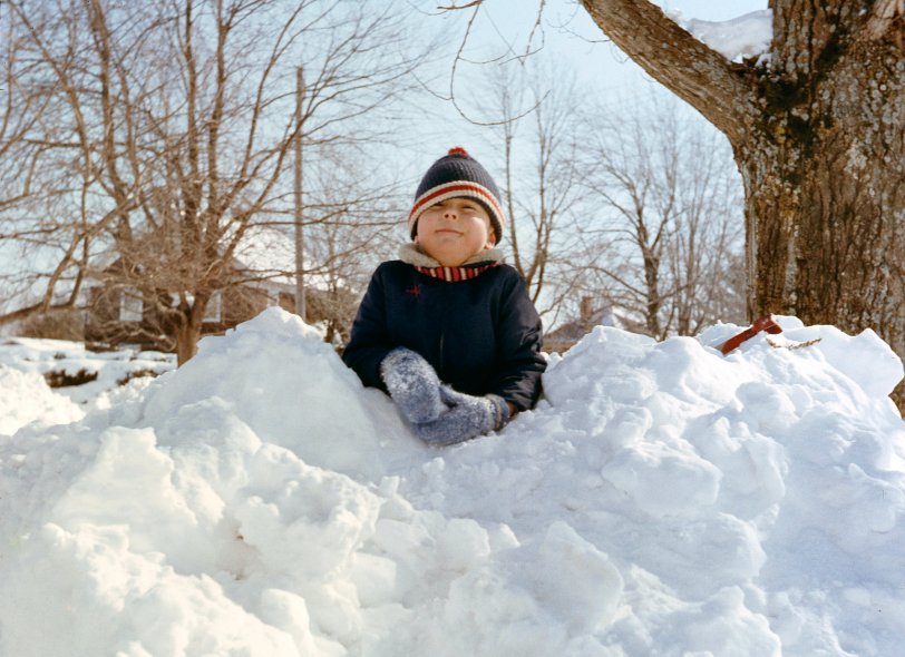 Another shot of winter in Bedford, Quebec in the late 50s. Here I'm looking proud of myself in the snow fort I built at the foot of our laneway. Living at the edge of a small town, we often went tobogganing on nearby countryside hills and skated until our feet were tingly-numb on the frozen creek that wound its way out of town. As Joni Mitchell sang (a fellow Canadian), "I wish I had a stream I could skate away on" and we did. How lucky we were. View full size.
