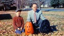 This is me, my dad, our cocker spaniel Cyndy and Dad's huge pumpkin. Bedford, Quebec, 1958. View full size.
Vent holesI see your dad used an apple corer to produce perfectly symmetrical vent holes in the lid of the pumpkin.  I've always had scorch marks on the underside of the lid from the candle placed at the bottom of the pumpkin, and must assume he was being cautious about the fire part of the jack-o-lantern.  I love the way he has his hand on his carving job in a proud, proprietary kind of way.
(ShorpyBlog, Member Gallery)