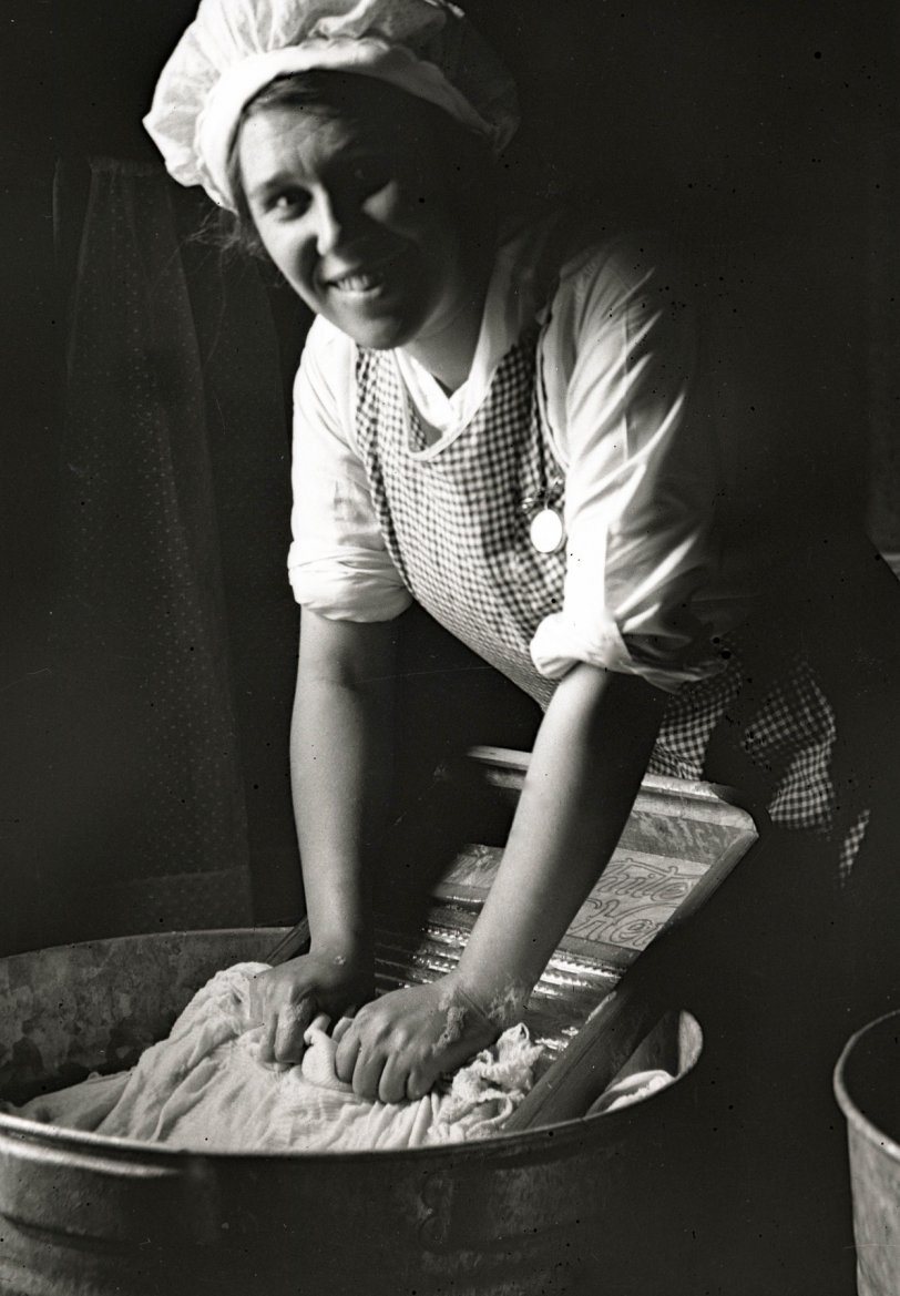 While the lady of the house was well-dressed in most of the photos, she was also a housewife.  Here she is doing the laundry with a smile.  It's easy to forget that this was the way it was done back then.  The watch must have been important to her, because she is wearing it in most of the pictures, even here, with soap suds halfway up her arms. From the collection of film and 4x5 glass negatives I recently purchased. We would love to find out more about this family; they evidently lived somewhere in Central New York, so their relatives could be our neighbors. View full size.
