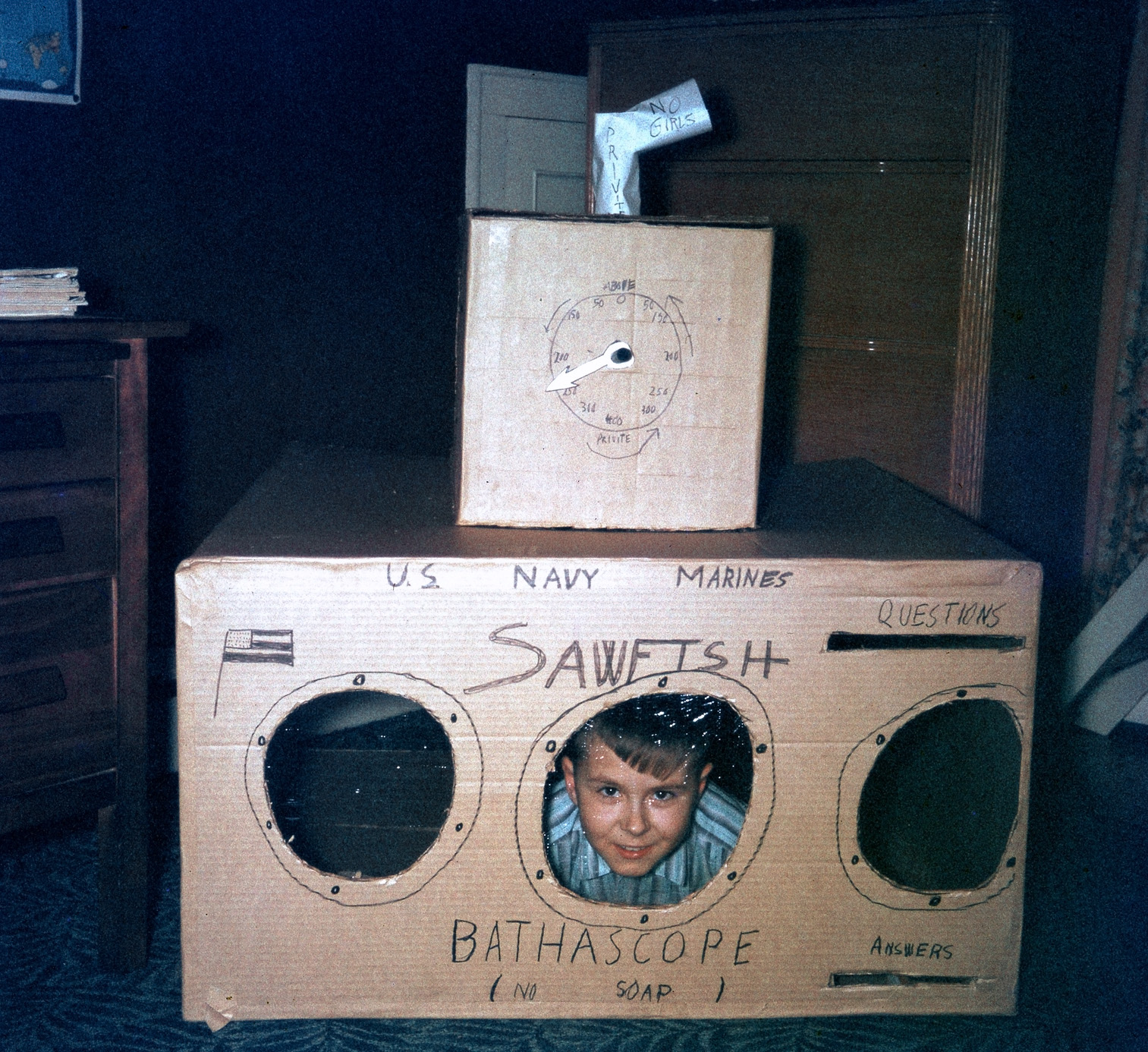 After the bathyscaphe Trieste descended to the deepest part of the ocean in January 1960, I made a "copy" out of cardboard boxes, cellophane and marker pens Dad brought home from work. That's me as a nine-year-old explorer at the window. View full size.