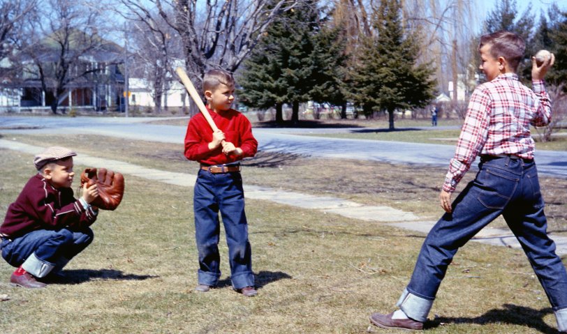 This is one of our dad's posed shots, me the little guy at bat, along with my brothers in our front yard, Bedford, Quebec, late 1950s. View full size.
