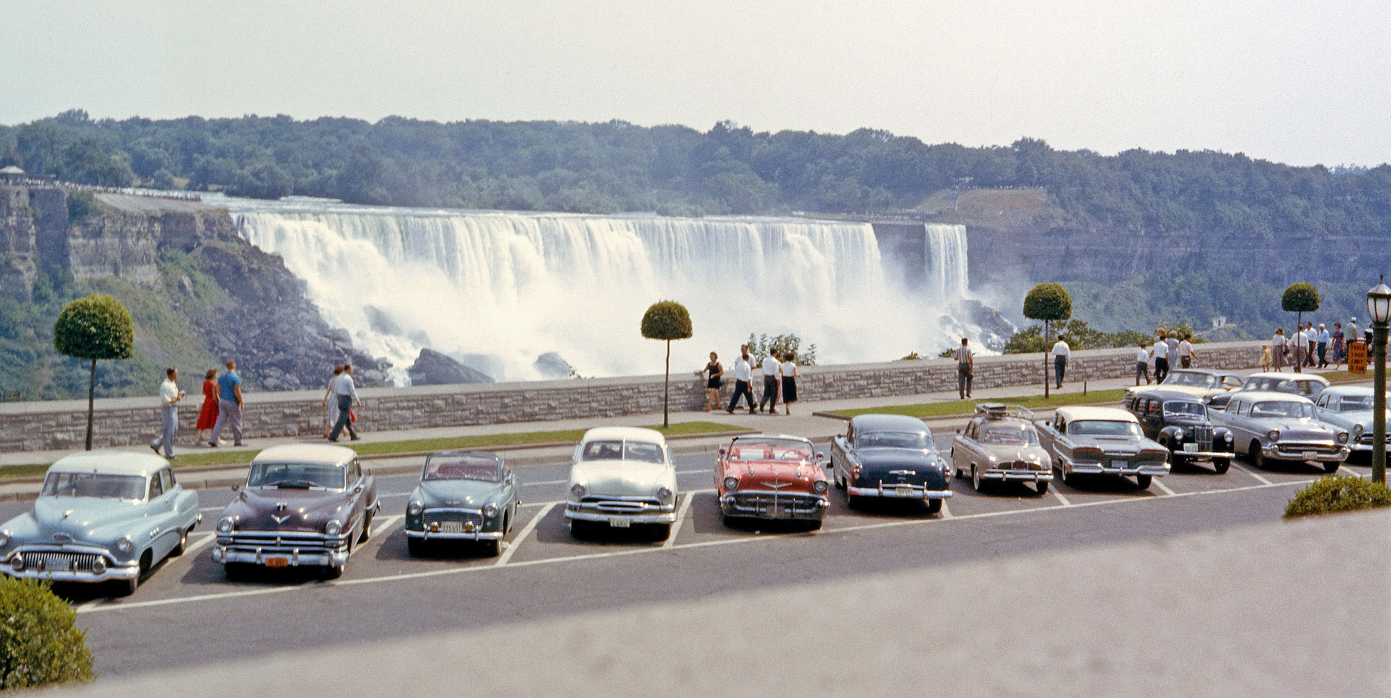 Shot taken using 35mm Kodachrome on the Canadian side of the Falls in 1958. Note the array of British and French cars among the American classics in the parking lot. Today, only tour buses are allowed in this area. The movie "Niagara," starring Marilyn Monroe, filmed the motel scenes (temporary props) off to the left of the picture at the gorge edge in 1954. View full size.