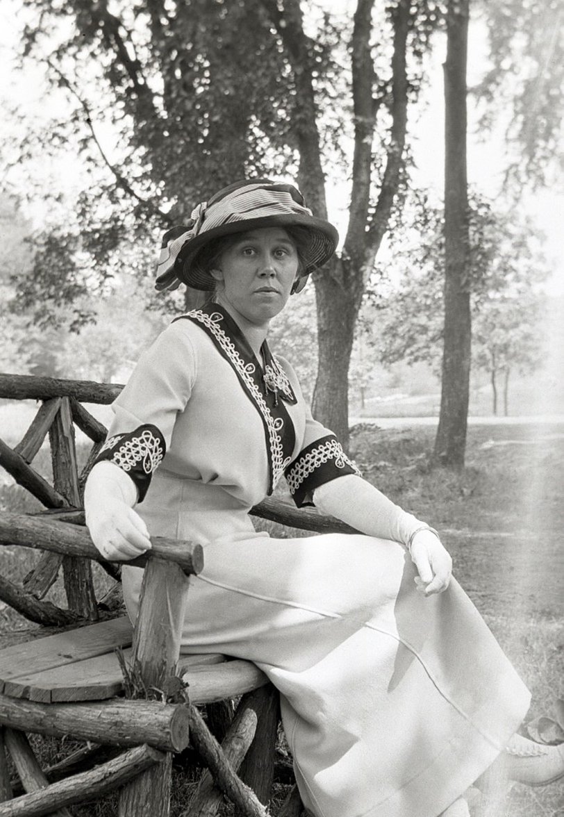 From the collection of film and 4x5 glass negatives I recently purchased that seem to have been taken in upstate New York about 1912. This is from a film negative that has been bent, hence the flare on the right side.  The lady's dress is spectacular, and she is coordinated with gloves and white shoes.  I don't think this was an inexpensive outfit. View full size.
