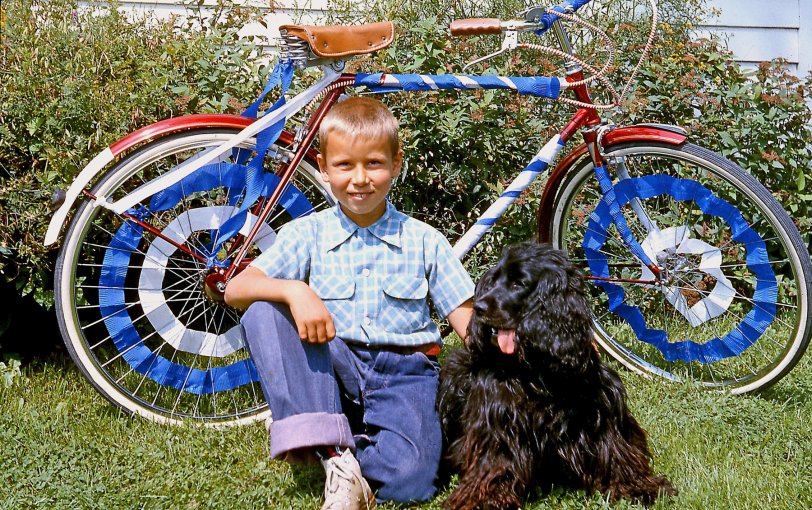 June 24, 1959. My brother posed proudly with our cocker Cindy in front of his decked-out bike for the annual St. Jean Baptiste Parade in Bedford, Quebec. It was ironic that an English kid led the bike parade celebrating French Quebec's "national" day of celebration. View full size.