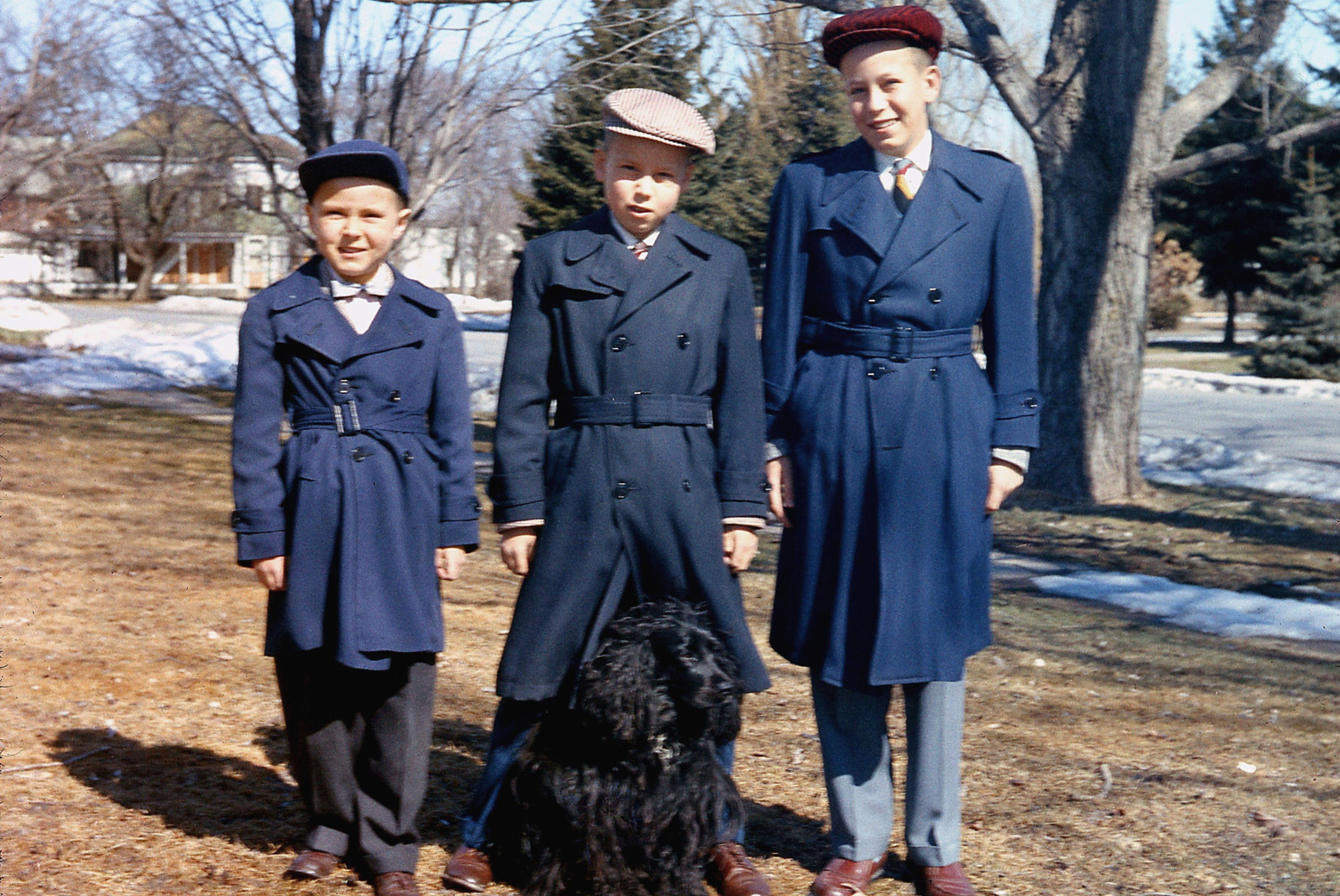 For some reason, "car coats" were popular in the late 1950s (maybe a throwback to the early auto age?), and here is an excruciating shot of me and brothers prior to a road trip. As usual, my next-oldest brother is hamming it up for Dad. View full size.