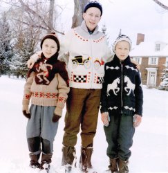 Here're my brothers and me, late 1950s Bedford Quebec, wearing sweaters that my aunt knitted for us. They were amazingly warm (were they wool?) and she put a lot of work into them. I'm on the left, in the now-cringe worthy "Indian on the warpath"-themed motif. View full size.
Definitely woolBack in those years, Islander800, your aunt in Quebec would most certainly have been using wool.  My mom didn't discover acrylic until the mid-to-late sixties, and I like to think she was on the cutting edge of all things knitting.  I include two of her wool creations below: the cowboy sweater (to chase your Indian) was my older brother's and the choo-choo train was mine, both knitted circa. 1963, making them over 50 years old.  I still have them: took those photos today.
Wow!As a knit nut, I see your Aunt was a patient and talented woman. They are so cool. Reminds me of Beaver's Eskimo sweater.
(ShorpyBlog, Member Gallery)