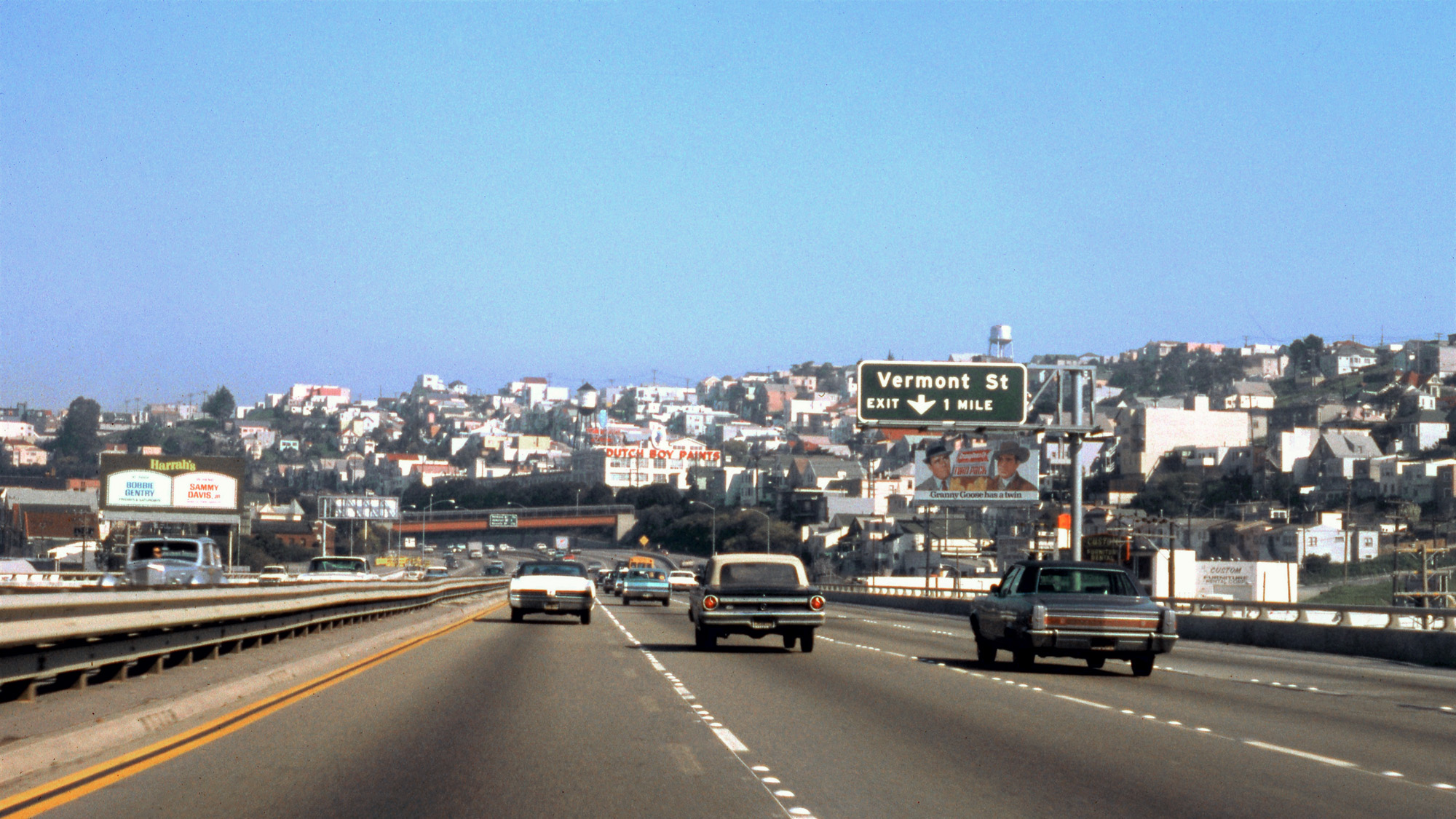 San Francisco, March 1969. Taken from the front passenger seat, US 101 northbound at the Vermont Street exit. Love the Bobbie Gentry and Sammy Davis Jr. Harrah's billboard and the late 1950s Bentley cruising serenely in the southbound lane. View full size.