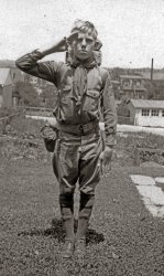 Jack Pernet in his Boy Scout uniform, sometime in the late 1910s or early 1920s. Jack probably belonged to Troop 158 in Phoenixville, Pennsylvania, where this photo was taken. In the background on right is a tall smokestack belonging to the Phoenix Iron Company, which, despite the closure and subsequent demolition of the plant in the 1980s, miraculously still survives.  Its location pinpoints the photo as being taken in the back yard 393 Washington Avenue in that borough, where the Pernet family lived for many years. Jack, a graduate of Phoenixville High School's class of 1926, lived to see its 70th reunion but died in 1997. View full size.