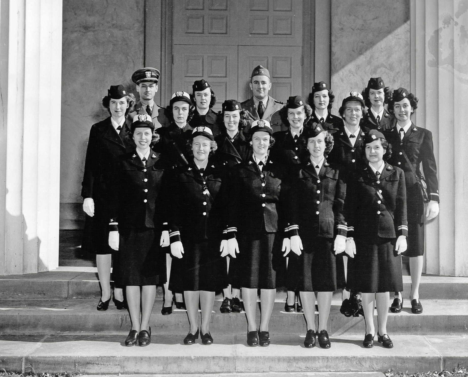 This was taken on the front steps of the Chapel of the Naval Communications Annex (the former Mt. Vernon Academy), 3801 Nebraska Ave, Washington, DC.  At the time it was taken, Mom (second row, second from right) was an officer in the WAVES.  We know nothing more about this photo, but we assume this was the group of people she worked with.  Perhaps one of these people is your (grand) mother or father, and you have one of the other 15 copies that must exist of this photo.  If this is the case, I'd love to hear from you.

What did she do, you ask?  Well, we're not sure of the details, and we can't ask her, because she died in 1985.  But we're pretty sure she was breaking codes, either German or Japanese ones, by machine.  She was 22 when she entered the Navy in January 1942, the child of a well-to-do Boston family (her dad was a surgeon, her mother a society lady).  She served throughout the war, worked at CIA for a while, got married and then became a housewife and mother.   She remained very quiet about this work for the rest of her life, and my brother and I never grilled her about it.  Now we wish we had asked a few more questions. View full size.