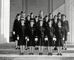 This was taken on the front steps of the Chapel of the Naval Communications Annex (the former Mt. Vernon Academy), 3801 Nebraska Ave, Washington, DC.  At the time it was taken, Mom (second row, second from right) was an officer in the WAVES.  We know nothing more about this photo, but we assume this was the group of people she worked with.  Perhaps one of these people is your (grand) mother or father, and you have one of the other 15 copies that must exist of this photo.  If this is the case, I'd love to hear from you.
What did she do, you ask?  Well, we're not sure of the details, and we can't ask her, because she died in 1985.  But we're pretty sure she was breaking codes, either German or Japanese ones, by machine.  She was 22 when she entered the Navy in January 1942, the child of a well-to-do Boston family (her dad was a surgeon, her mother a society lady).  She served throughout the war, worked at CIA for a while, got married and then became a housewife and mother.   She remained very quiet about this work for the rest of her life, and my brother and I never grilled her about it.  Now we wish we had asked a few more questions. View full size.
Mom was very definitely DEcodingShe used to sing us the alphabet backwards, and told us stories about how hot it was in the office she worked in.  She was in charge of a number of "girls," and had absolute authority over who could come into her room.  This being the case, she allowed all the girls to strip down to their underwear in the DC summer heat. 
She taught herself Braille transcription at 50, loved crosswords, and claimed to be able to read 5-level Teletype tape by sight.  I never tested that.  The only hint about decryption that she gave us, was a comment that she was the one who had to figure out, when a message wouldn't decrypt, which key the cipher clerk might have hit in error as the ship rolled. 
As I said, if I knew then what I know now, I would have asked her a lot more questions.
Pre NSAThe Nebraska Ave facility, as I remember from the 1960s, was more of a cipher/code making facility. 
(ShorpyBlog, Member Gallery)