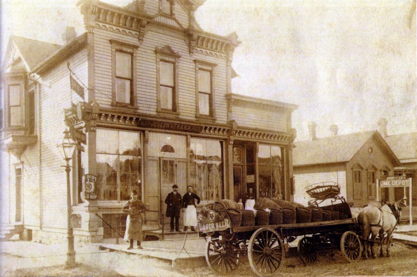 Beer delivery to Joseph Straka Beer Hall, Milwaukee, WI. Photo taken in the 1890's. Man in apron, Joseph Straka. In doorway to the right Josephine Straka, his wife and one of their children. Assume the man standing near the front of the sidewalk is the wagon driver. This building still stands on Washington Street. The Strakas are my great grandparents, they lived in the upper story of this building.
