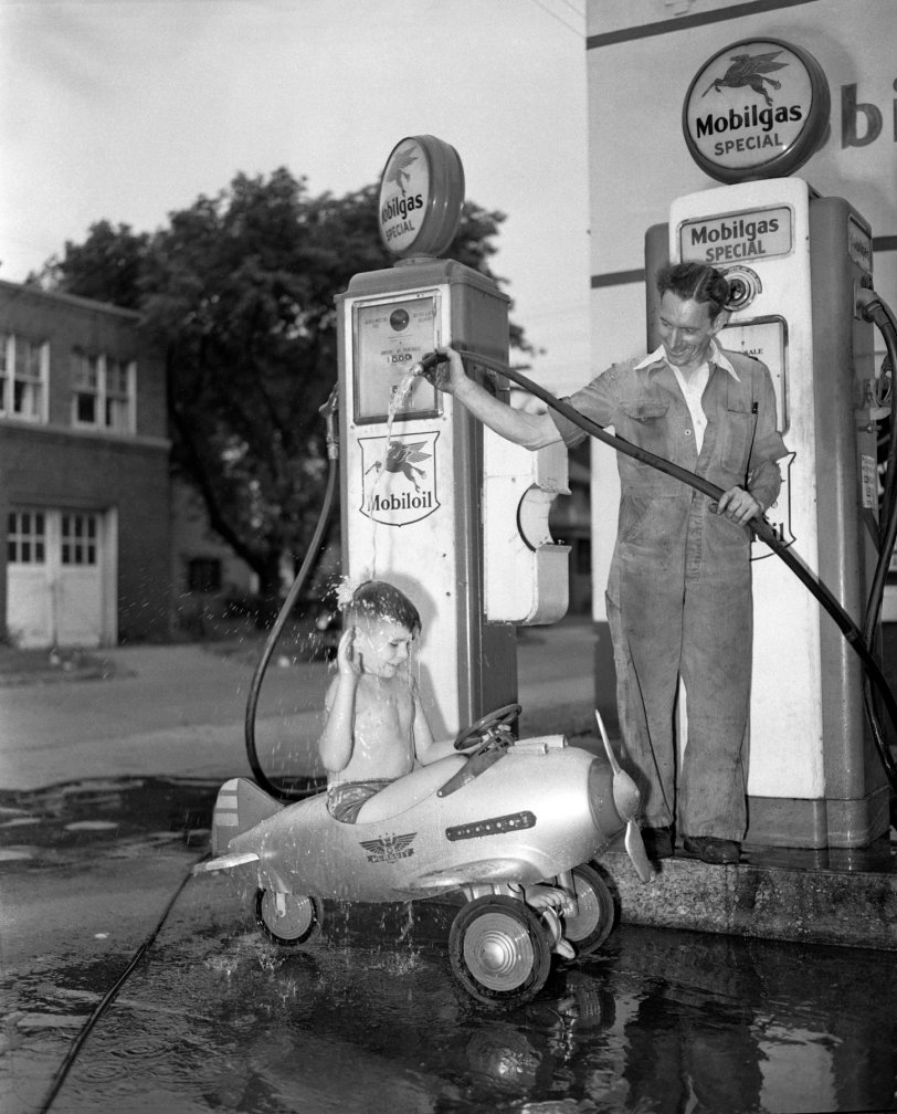 My grandfather Howard McGraw, a photographer for the Detroit News, likely saw the scene in his neighborhood and stopped for the shot. The airplane is an early 1940's Murray Pursuit pedal car with Army decals and machine gun mounts - worth over $1000 today if restored! And the gas pump would likely go for about $3000 restored!  Scanned from a 4x5 negative. View full size.
