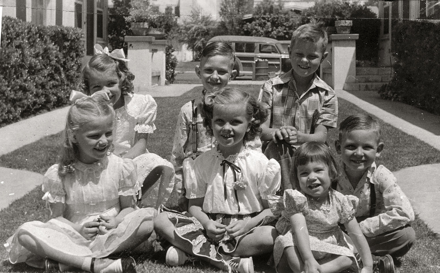My dad around 8 years old or so, which would make this around 1946. He's in the back row on the right. My Aunt Susan is second from left, front row. Not sure exactly where it was taken other than somewhere in Los Angeles. I am thinking the other kids are cousins but I don't know their names. Or just friends. Just amazed you can get a group of kids to sit still while you snap a picture of them. I'd love to have the car in the background. View full size. [Where is this? - Dave]