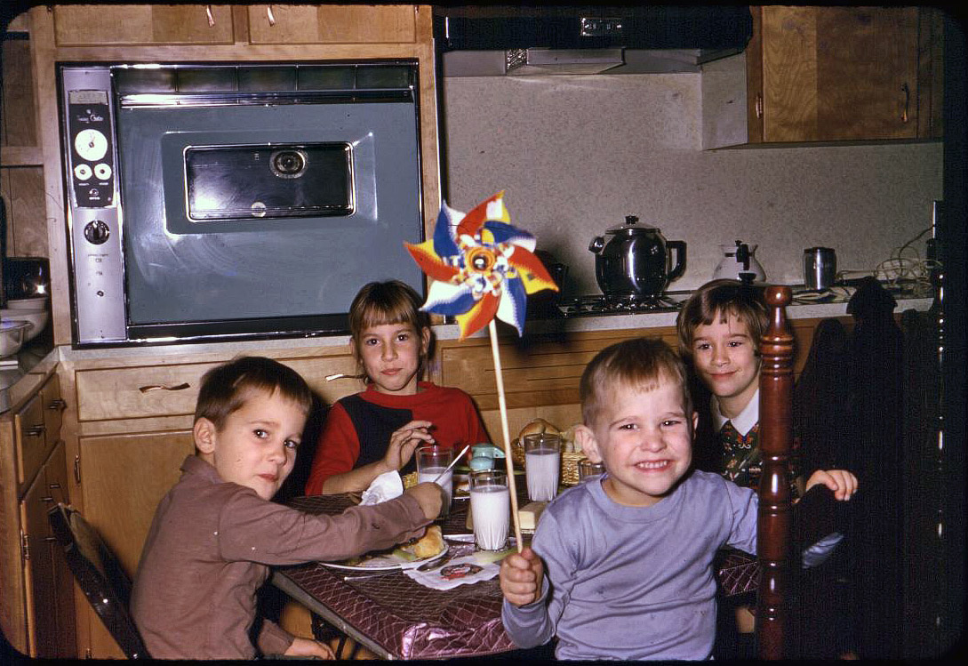 The kids' table in my mother's newly remodeled kitchen in Mount Airy, North Carolina. I'm the girl on the right. It's either Thanksgiving or Christmas 1966. Kitchen is still the same except the oven door was replaced with a white one sometime in the 1980s.  Kodachrome slide. View full size.