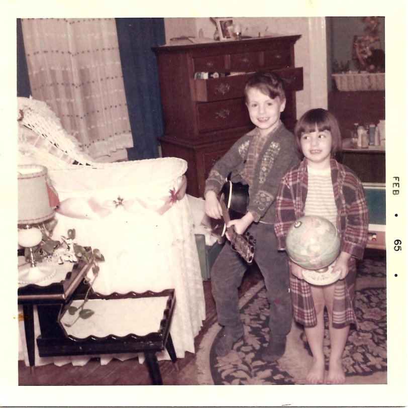 The second image of my older brother and sister from early 1965. My brother likened himself to Paul McCartney, and wore the strings off his guitar. By this time my sister had apparently traded in the drums for a globe (another recent Christmas present). View full size.

