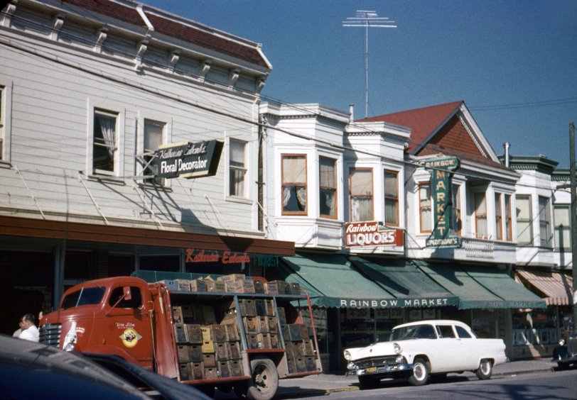 Larkspur, California, the small town I grew up in, about 15 miles north of San Francisco. Here in 1955 the population was around 3500. Within its three-block downtown there were: two grocery stores, both with full service butchers (here the Rainbow Market, or "Ernie's," and next door The Food Center, or "Fred's"); a drug store, where I also bought my comics and had my film developed; a hardware store with everything from bins of nails to small appliances; a variety store, where I bought my Matchbox cars; a dry goods store; two barber shops; a movie theater; my doctor and dentist; a TV repair shop; a soda fountain; a caterer; a florist (on the left in the photo), as well as the gas station, garage, post office, bank, fire house and city hall, the latter with the library. Oh yeah, and three bars. I never went to those, but you could often find me at the library investigating dinosaurs or old coins or freeways or whatever else I happened to be obsessed with at the moment, all with the indulgence and encouragement of Miz Wilson, the long-time librarian. 35mm Ansco Color slide by my brother.
View full size.
