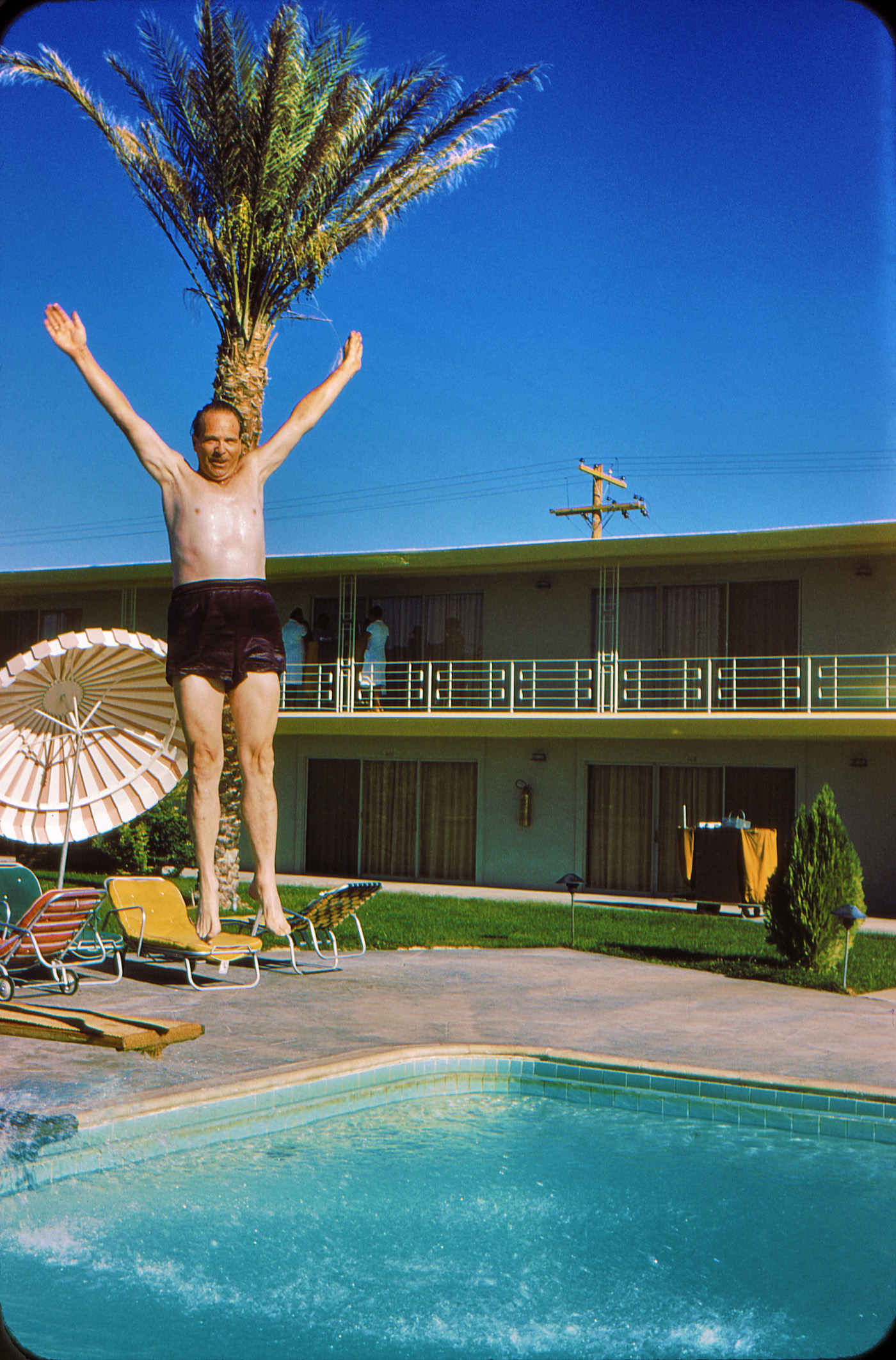 Mid-1950s. An unknown pool patron makes like a tree and jumps in to escape the heat in Las Vegas. Scanned from the Kodachrome slide. View full size