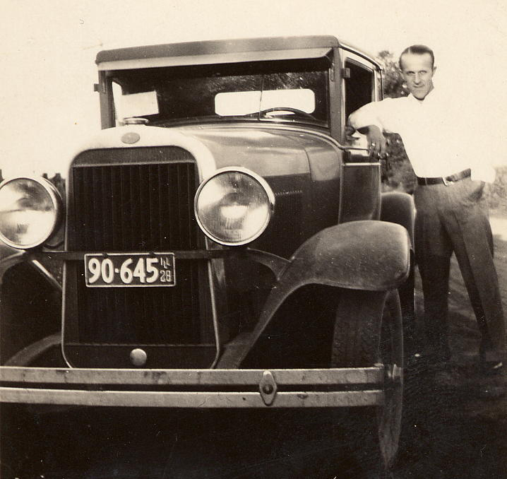 Here's a picture of my grandpa, Leonard Hermonson, and one of his many cars. I'm thinking it's a Ford because of the oval on the radiator housing. From looking at the tag, he would have been around 25 when the picture was taken. I love cars. My dad says that I get the "gas in my veins" from my grandpa.
