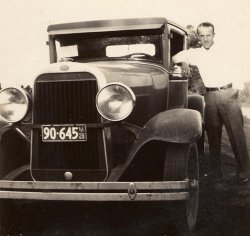 Here's a picture of my grandpa, Leonard Hermonson, and one of his many cars. I'm thinking it's a Ford because of the oval on the radiator housing. From looking at the tag, he would have been around 25 when the picture was taken. I love cars. My dad says that I get the "gas in my veins" from my grandpa.
(ShorpyBlog, Member Gallery)
