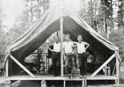 My first thought was 3 men camping, then when I saw this shelter tent placed on logs my thought was loggers. I have no clue as to who they are or what year it was taken.
(ShorpyBlog, Member Gallery)