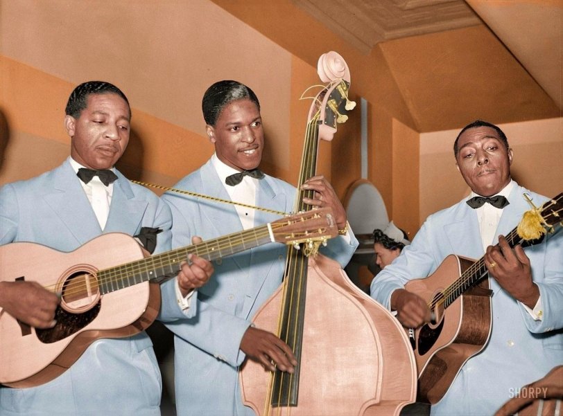 April 1941. "Entertainers at Negro tavern. South Side Chicago." On the left is Lonnie Johnson, noted blues man and pioneering jazz guitarist. View full size.
