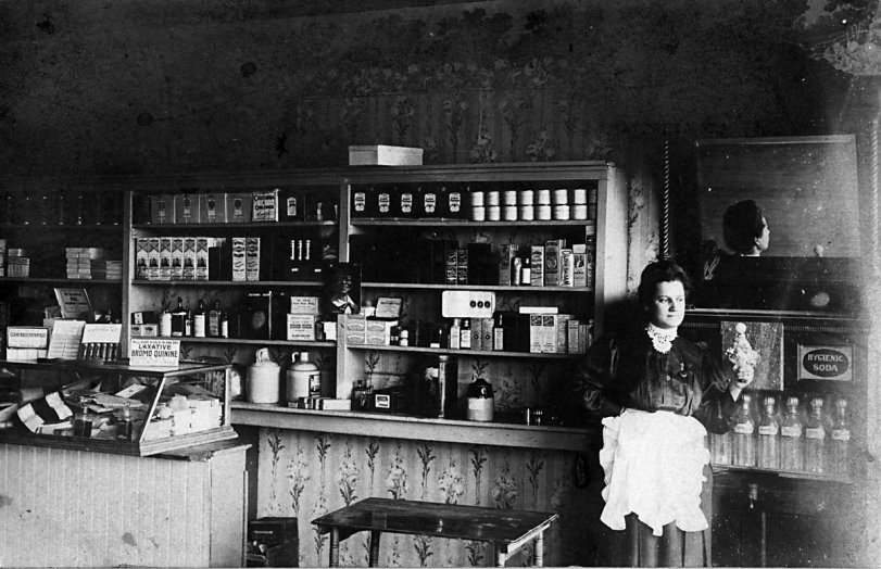 Found this companion photo to my previous post. Shows the other side of the pharmacy in Louisville, Kansas. The woman is "Doc" Cutright's wife, Pearl. View full size.
