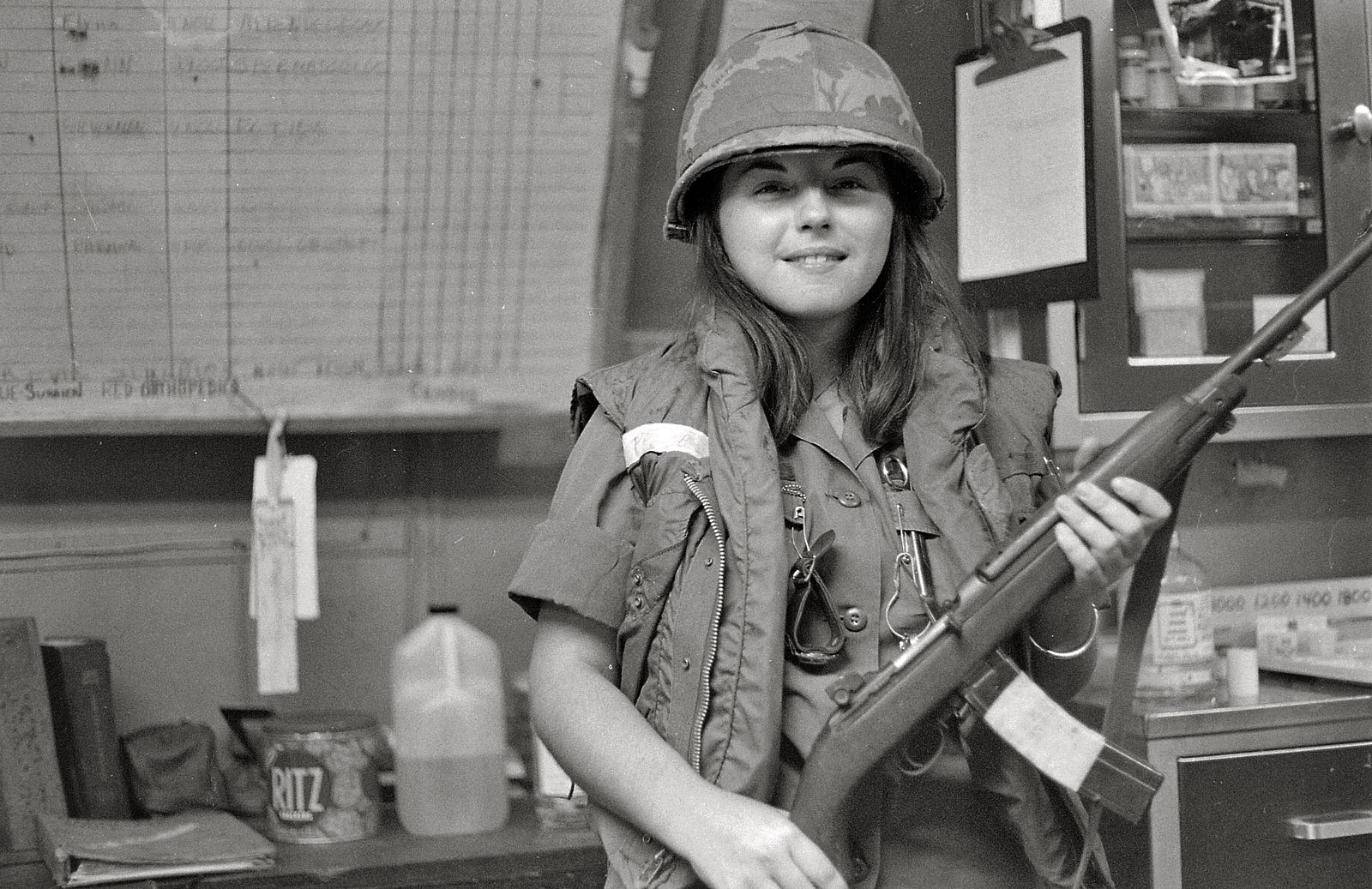 My mother in Vietnam, 1969.  Her hospital was on alert for one reason or another, and she decided to have a picture taken with a soldier's M1 carbine.  As a nurse, she of course didn't have her own personal weapon. View full size.
