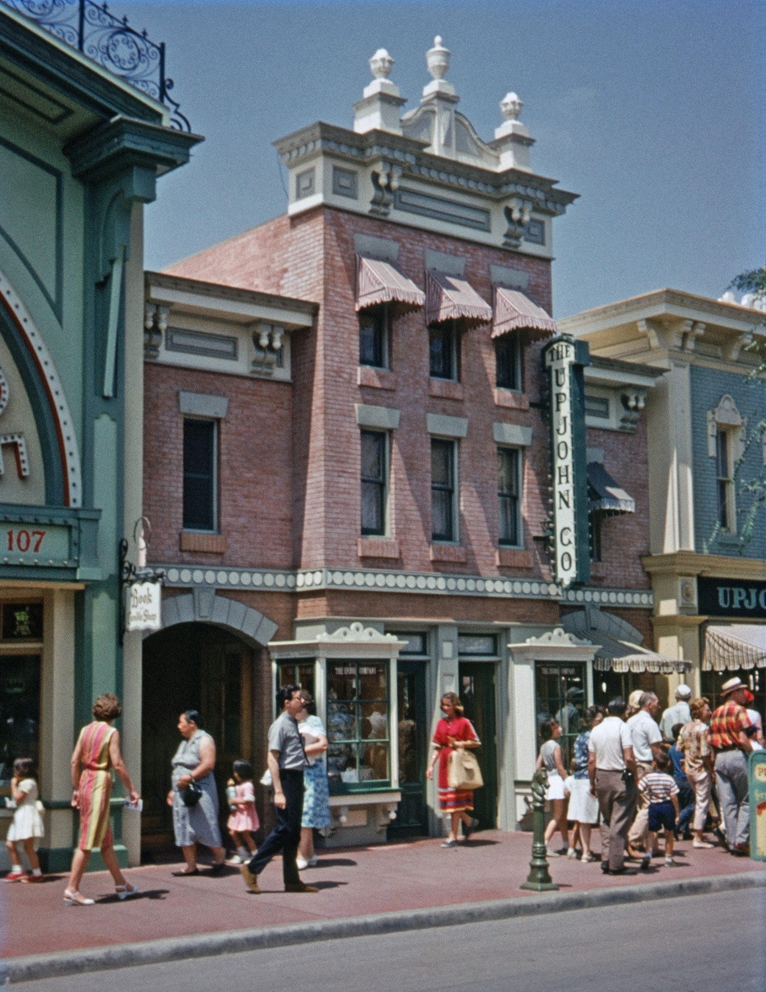 The other day, Shorpy posted this photo of Saratoga Springs, which Dave described as "looking more than a little like one of those idealized Disney 'Main Streets'." One perspicacious commenter pointed out that Disney's relationship to the historic period portrayed in his Main Street (approx. 50 years past), would be like ours to the 1950s and 60s. So here you have it: Main Street in Disneyland, August 1963, roughly at the mid-point between the then-then and now. That's my brother in the gray shirt and Hush Puppies caught in mid-stride. I was just turning 17 when I shot this on Montgomery Ward's house-brand 35mm color slide film. View full size.