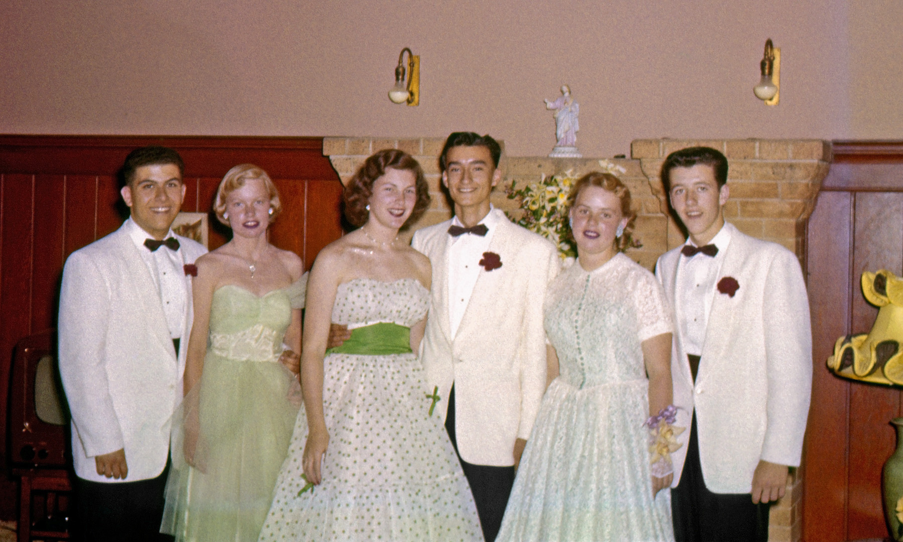 My brother's Marin Catholic High School classmates all decked out for their 1955 Senior Prom. He took this Ektachrome slide in the Larkspur, California, home of the girl on the right. 1950s accouterments include a table model TV set, spectacular lamp shade and those interesting light bulbs, a variety we also had in our own home a couple blocks away. View full size.