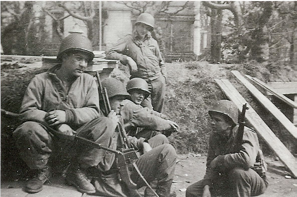 Men from the 526th Armored Infantry Battalion rest a moment during a reconnaissance mission in the Ruhr Pocket near Frankfurt, Germany, Spring 1945. From left to right, Saba Herrere, Jack Mocnik, Chris Breuninger, Louie Belezzuoli and Harlan Baker. View full size.