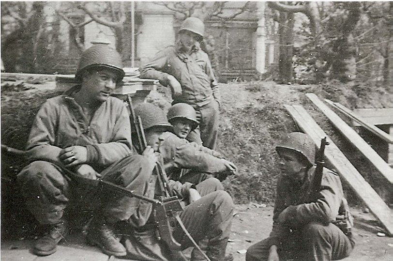 Men from the 526th Armored Infantry Battalion rest a moment during a reconnaissance mission in the Ruhr Pocket near Frankfurt, Germany, Spring 1945. From left to right, Saba Herrere, Jack Mocnik, Chris Breuninger, Louie Belezzuoli and Harlan Baker. View full size.
