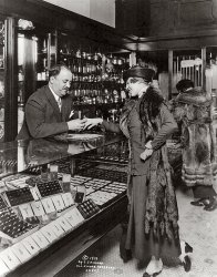 The Library of Congress title says this lady is "trying on a ring in Kohn’s, Minneapolis." One hates to question the LOC, but they mislaid a vowel. That's Max A. Kohen. For decades he ran a jewelry store known for its exuberant public relations and easy-credit promises; the newspapers of the teens and 20s always had a picture of laughing M. A. K., face cleaved by his grin. [View full size.]

The customer? Annette Kellerman, the million-dollar mermaid, proponent of the scandalous one-piece bathing suit, and the first woman to attempt to  swim the English Channel. She had a sister in Minneapolis. [Annette's bio | Max's bio]

Max's old store in the Loeb Arcade, and his streamlined store in 1936.