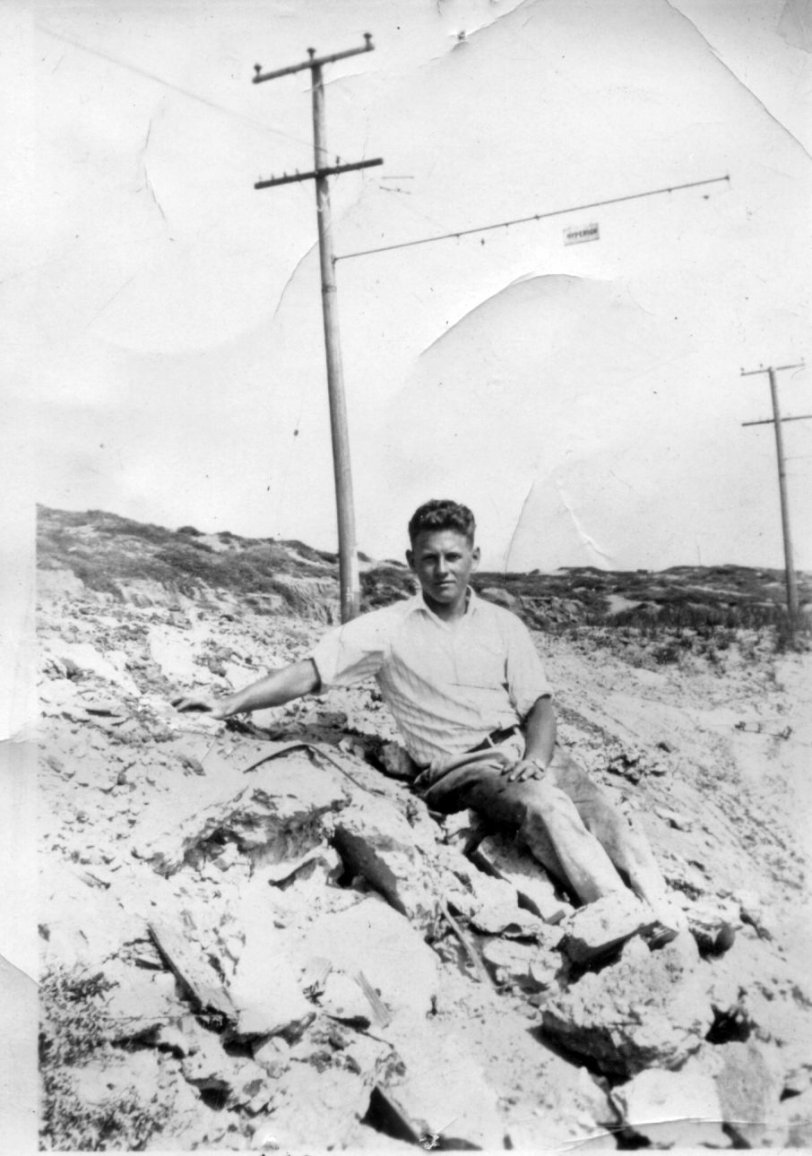 The only caption on this photo says "Me." I am assuming this is my grandfather Frank Hallack in his early 20's, which would make this photo as one taken during the 1930's. Possibly taken near the ocean. I wish I could read the sign that is hanging there, I think it could be something related to the Pacific Electric red cars line. View full size.
