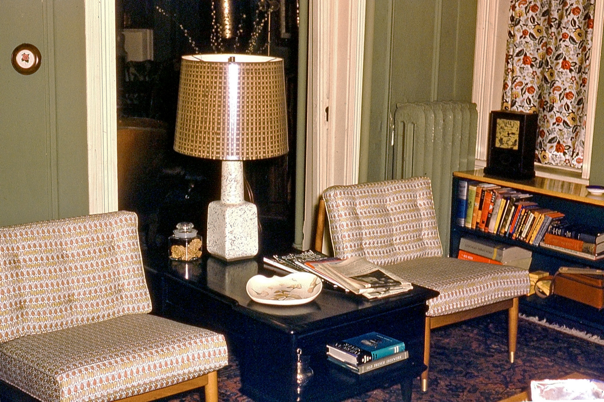 An unmarked Kodachrome slide brings this interior of a 1950s home with a mixture of old and new. I'll take the chairs, lamp and bookshelf. Of particular interest to me are the yellow Kodak boxes and camera case on the lower shelf to the right - possibly some of the very same boxes that I'm working with right now? View full size.