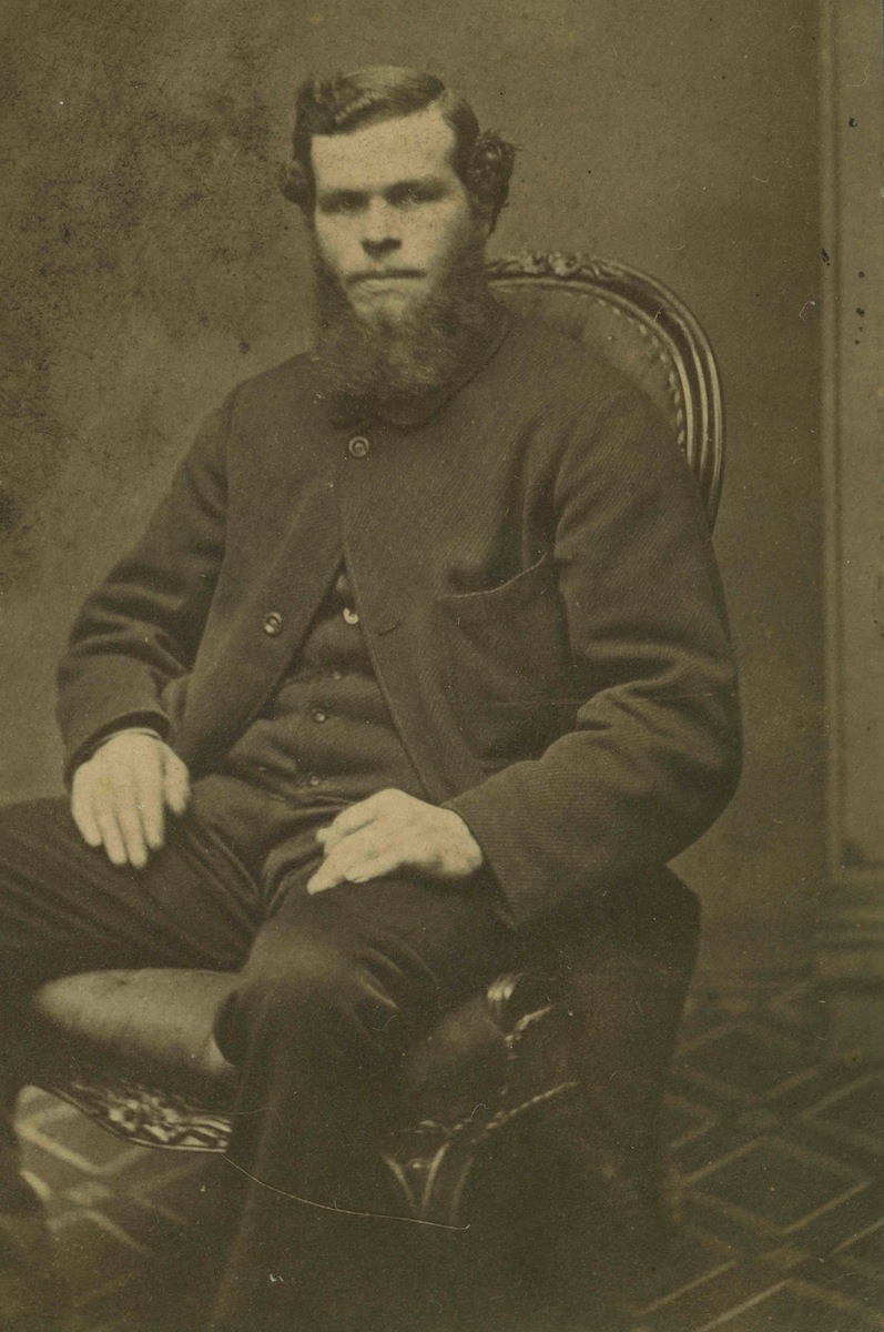 A miner from California went north to British Columbia where a new gold rush was taking place in 1858.  His photo is an example of a very early albumen paper print, which could have been taken in San Francisco or Victoria.  The picture was cut down, removing the maker's name.  Some photographic studios of the time rarely changed the furniture, carpets, and backgrounds.  Looking through a thousand mid-nineteenth-century portrait photos has not turned up the studio.  Shorpy is renowned for photographic experts.  Does anybody recognize the photographer who took the picture? View full size.