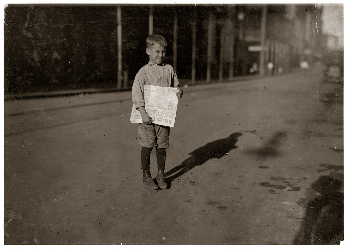 October 1914. Mobile, Alabama. "Young newsboy who begins work at daybreak." View full size. Photograph by Lewis Wickes Hine.