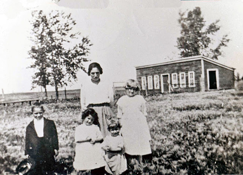 Here is my mom, Genevieve, the blonde girl standing next to her mom Anna Curran, on her First Communion day, on the farm near Fargo, North Dakota, I believe in 1921. Her three siblings Tom, Katherine, and Mary are in front.