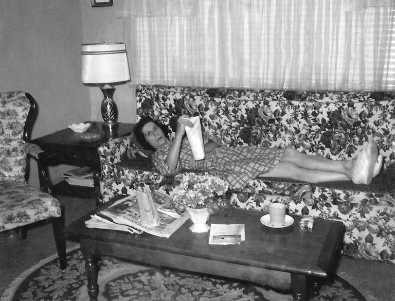 This is my late mom in the late 1960's (either '67, '68 or '69) lying on the sofa and reading the Sunday Daily News (New York's Picture Newspaper). The bulletin from nearby St. James parish rests on the table, so this was after church. The newspaper back page headline is a mystery in attempting to date this photo. Partially obscured and curved, it appears to have the words Bosox and Tigers, so possibly "Bosox Defeat Tigers", or "Bosox Lose, Tigers Win". Below that, all I can make out is "In Final". In that case, it wouldn't have anything to do with the the 1968 World Series, since that was Cardinals vs Tigers. Unless, what looks like "Bosox" is actually "Gibson". However, Bob Gibson did not pitch any Saturday games in that series, though he did pitch on Sunday, Oct 6. Given it is a NYC paper, they wouldn't have run a headline of a regular season game of a non-NY team, so my guess is that this is 10/6/68, during the 1968 World Series, and the headline was something like "Gibson To Face Tigers....". But I could be wrong. View full size.
