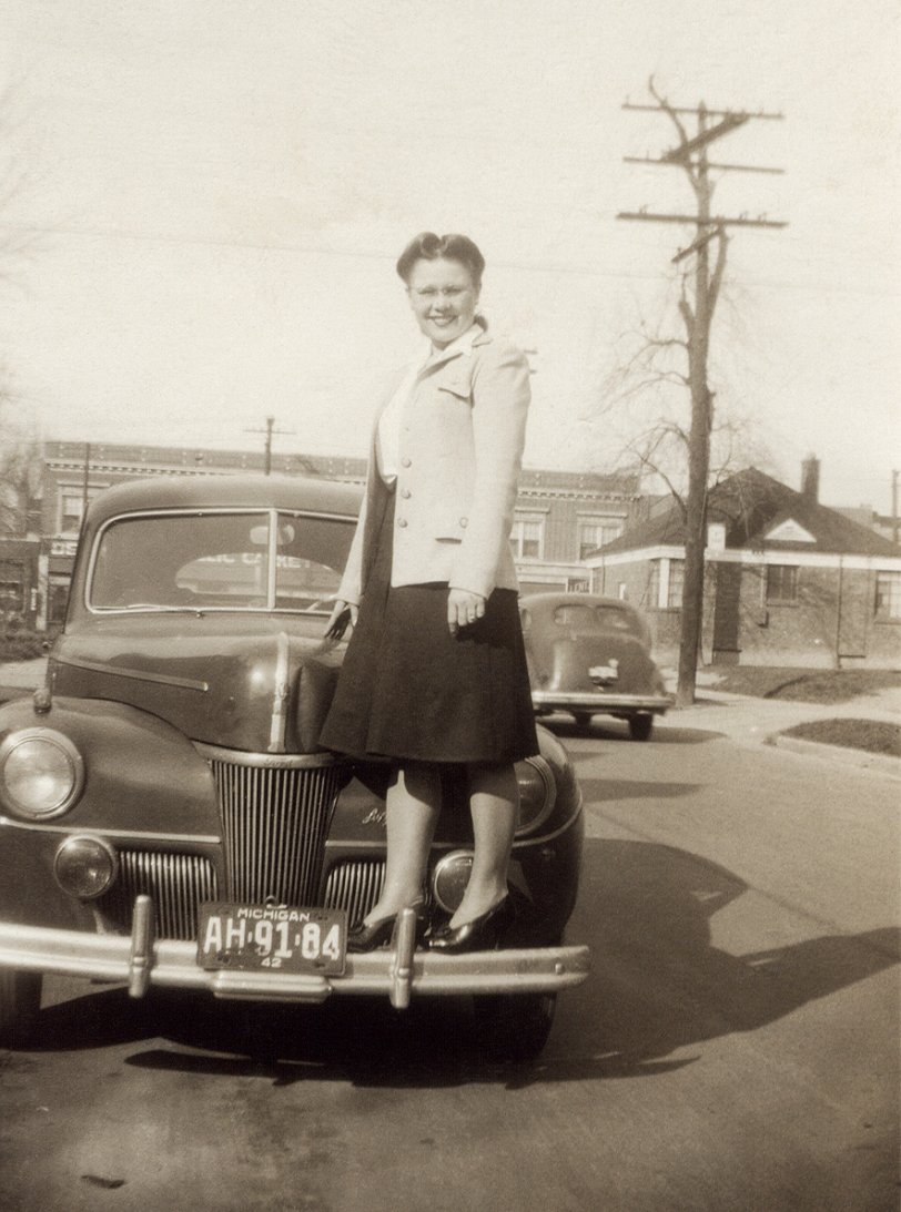 My mother, at age 23, Wayne County, Michigan, 1942.
When I was growing up, it seemed like she was always telling me to get down from something: kitchen counters, trees and even rooftops.  
Image courtesy of the Box of Curly Photos from my parents. View full size.
