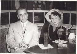My parents on a date at a downtown nightclub in the early 1950s. Now in their 80s, and married for 57 years, they both love this photo, and so do I. He was a Navy vet from a coal-mining town in Pennsylvania. She was born and raised in the city, and loved to dance. I love the coy look in her eyes. And I love that hat. I wonder what they were drinking, and what they talked about that night. They had their whole life ahead of them. View full size.
A great evening outMom and Dad at their nightclubbing best! I always refer to what your Mom was drinking as an "umbrella drink." I suspect Dad might  have a Long Island Ice Tea and Mom has a Mai Tai.
Thanks for posting.
Lovely coupleThanks for sharing your Mom &amp; Dad with us. They are an attractive couple. Lucky you they are still together. What a tribute to their love.
(ShorpyBlog, Member Gallery)