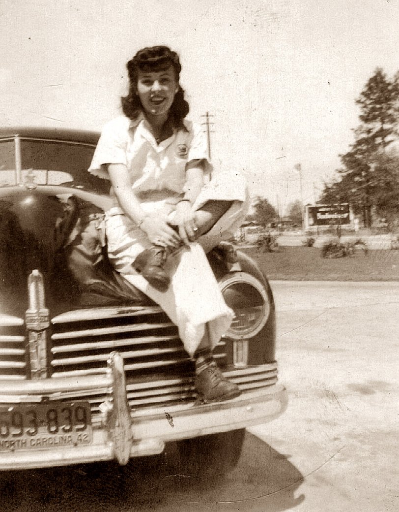 My mother in North Carolina during WWII.  I believe this was taken in the spring of 1942 somewhere near Camp Lejeune, where my father was stationed prior to shipping out to the South Pacific. They were married that February in Dillion, S.C. Looks like Mom was wearing some type of work uniform.   
