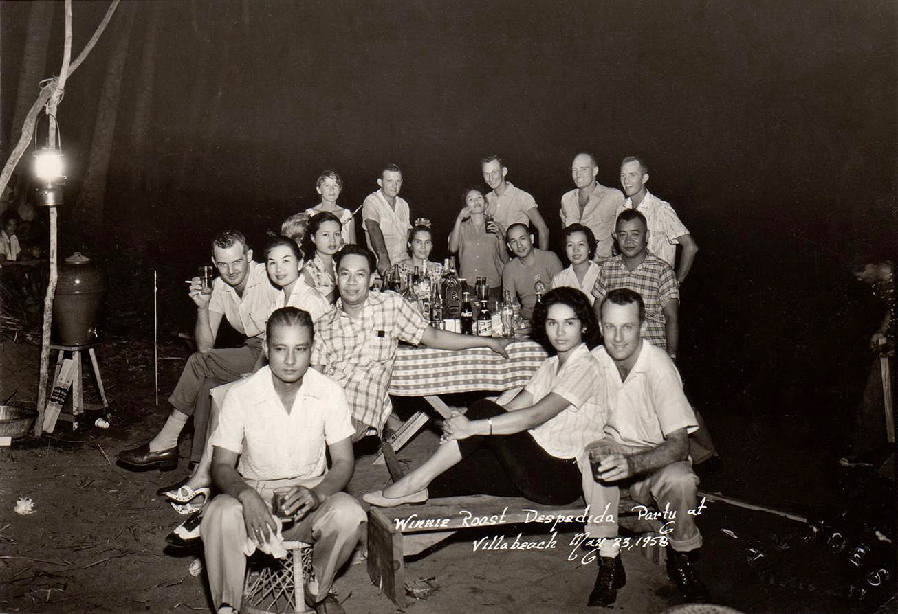 May 23, 1958. Mobil Oil employees at Villa Beach, Cebu, Philippines. My parents, newlyweds, are seated on the bench. All's good with Coke and San Miguel. View full size.