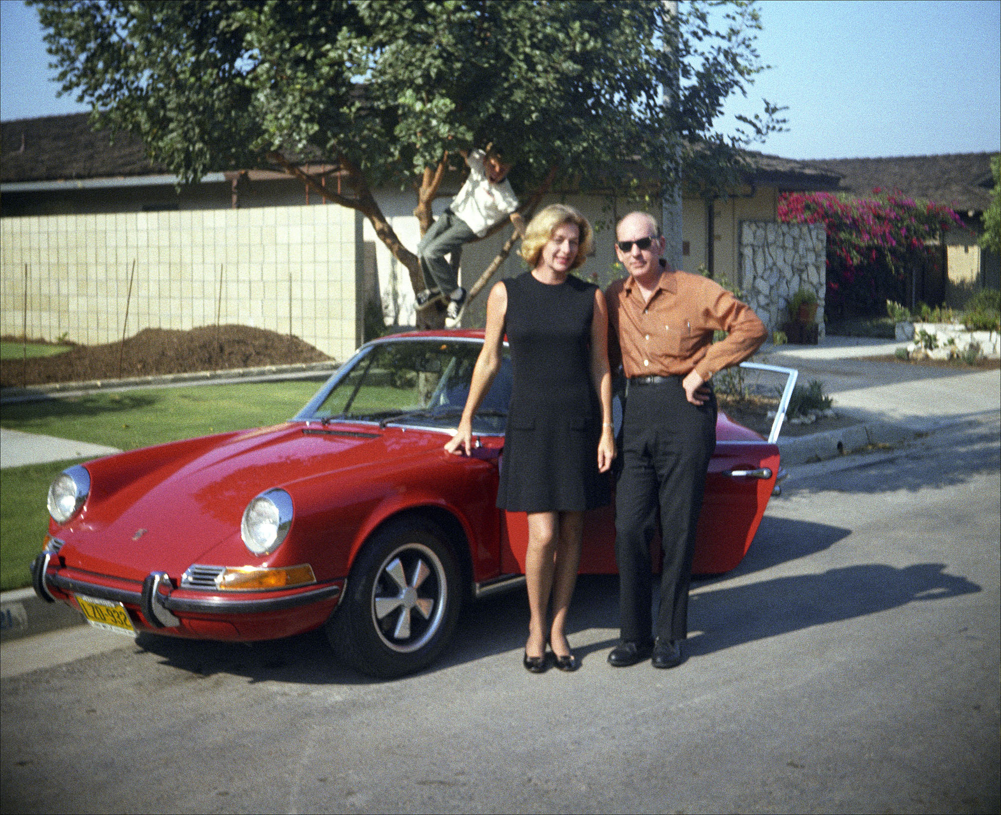My mother, Lea, with her brother, John, and his Porsche 912 in front of my parents’ house in the Shore Cliffs development of San Clemente, Calif., in 1969 or 1970. Scanned from the original 126 negative. My father was the photographer and the boy in the tree is yours truly! I have just been given boxes upon boxes of negatives and slides that my mother had kept in a closet for all these years. The prints are small, faded and almost colorless now. I hope to find many treasures in the following months. This is my first submission to Shorpy. View full size.