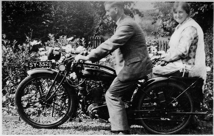 This is my wife's grandfather and grandmother. He was the manager of Bonnyrigg (Midlothian, Scotland) Gasworks. His surname was Bishop but strangely enough my wife can't recall his first name. The bike has been identified as a 1927 Model W Triumph. The photo was probably taken in the 1930s. View full size.
