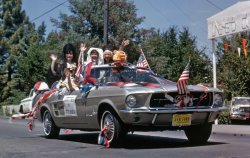 The 1967 Twin Cities (Larkspur & Corte Madera, California) Fourth of July Parade on the 300 block of Magnolia Ave. in Larkspur, right down the hill from our house. The "Leoettes" was an auxiliary of the Lions Club - see the toy lion over the windshield? Their garb commemorates the Spanish/Mexican history of the area; at the end of the block, the car will cross the boundary between two old Mexican land grant ranchos: Punta de Quentin (here) and Corte Madera del Presidio. Today this parade entry would be part of the vintage car contingent. This is a section of a 35mm Kodachrome slide. View full size.