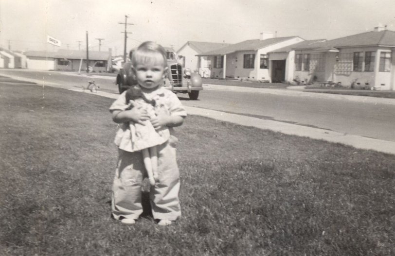 My aunt Susan, around two years old. According to my dad when he was alive, their neighborhood is now Parking Lot C for LA International Airport, which I believe since their street address of 9025 Goebel Avenue does not show anywhere on Google Maps to exist (I confirmed this from their WW2 food ration books I have saved). Or the street was renamed? Can anyone ID the car in the background?? View full size.
