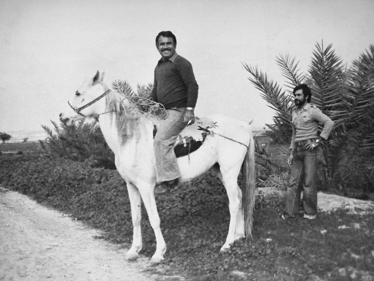 Iran, Bushehr, Bandar Ganaveh, Village Mall Mahmoud, April, circa 1970. My father (horseback) and Nasrallah Nazari.