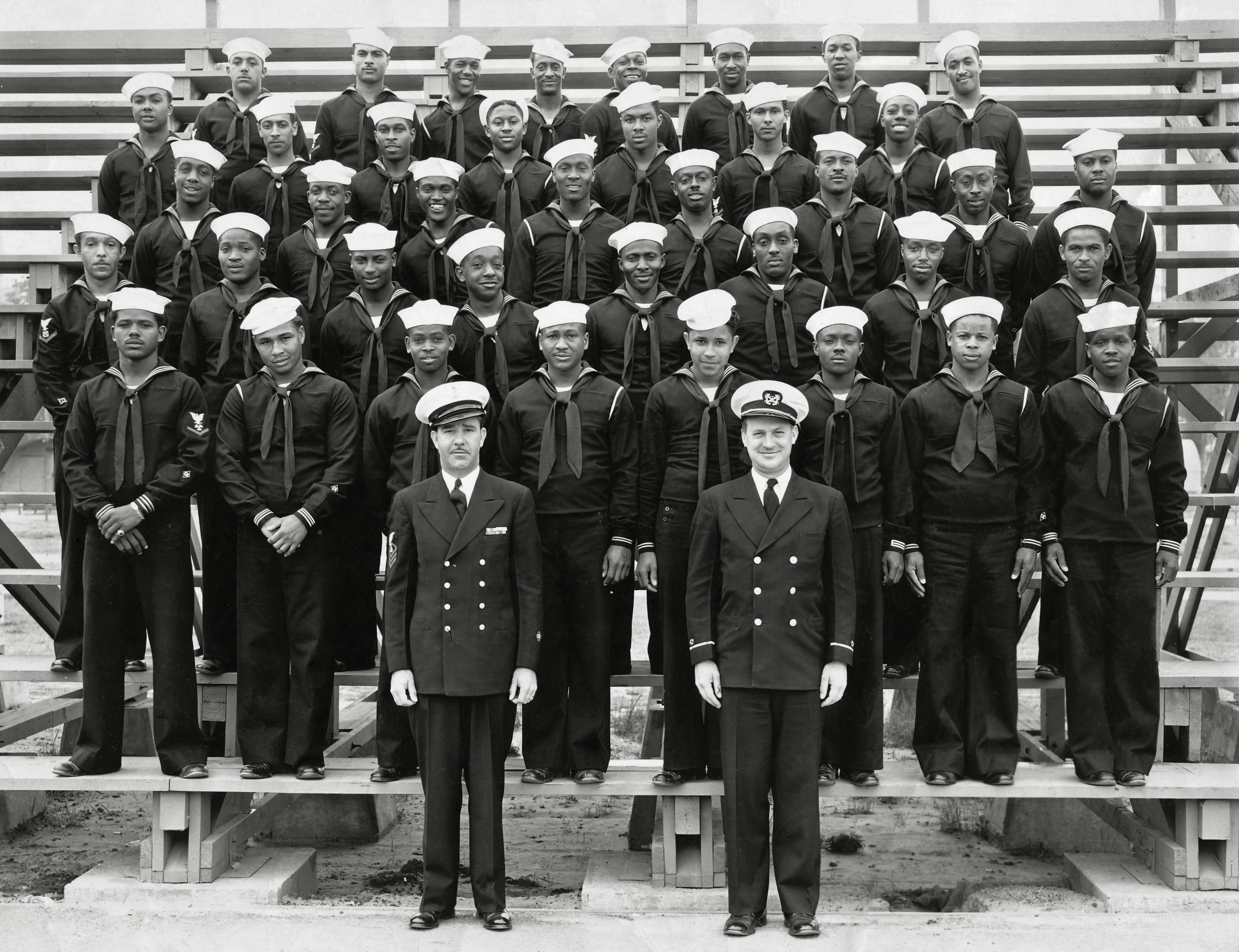 My grandfather Thomas A. Hawkins and his Navy peers in their enlistment group photo, about 1943. He enlisted in the Construction Battalion and was separated in 1953 as a Boatswain's Mate (Stevedore) Petty Officer First Class. This photo was taken either in Columbia or Charleston, S.C., where he entered). My grandfather is the second person directly above the head of the officer on the right. View full size.