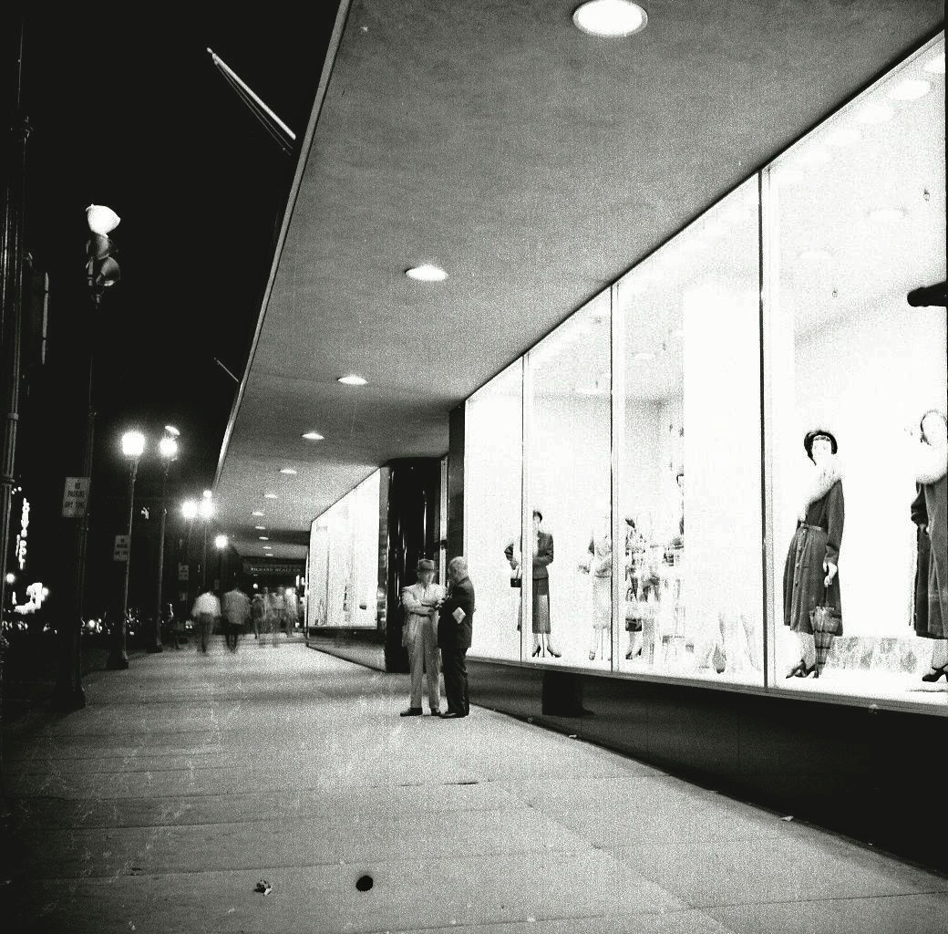 Street level view of the building lit up at night. From my negatives collection. 
UPDATE: The store is Denholm and McKay, Worcester, Mass. Open until 1973.
View full size.